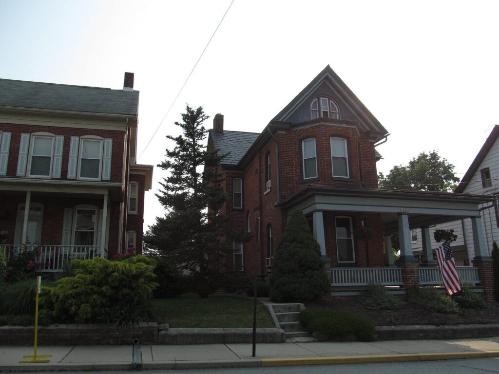 Brick Victorian homes with front porches on a street in Dallastown, Pennsylvania