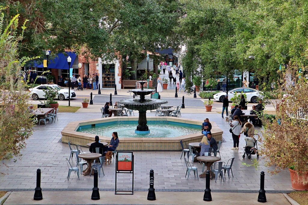 Fountain plaza with outdoor seating and shops at Hyde Park Village in Tampa