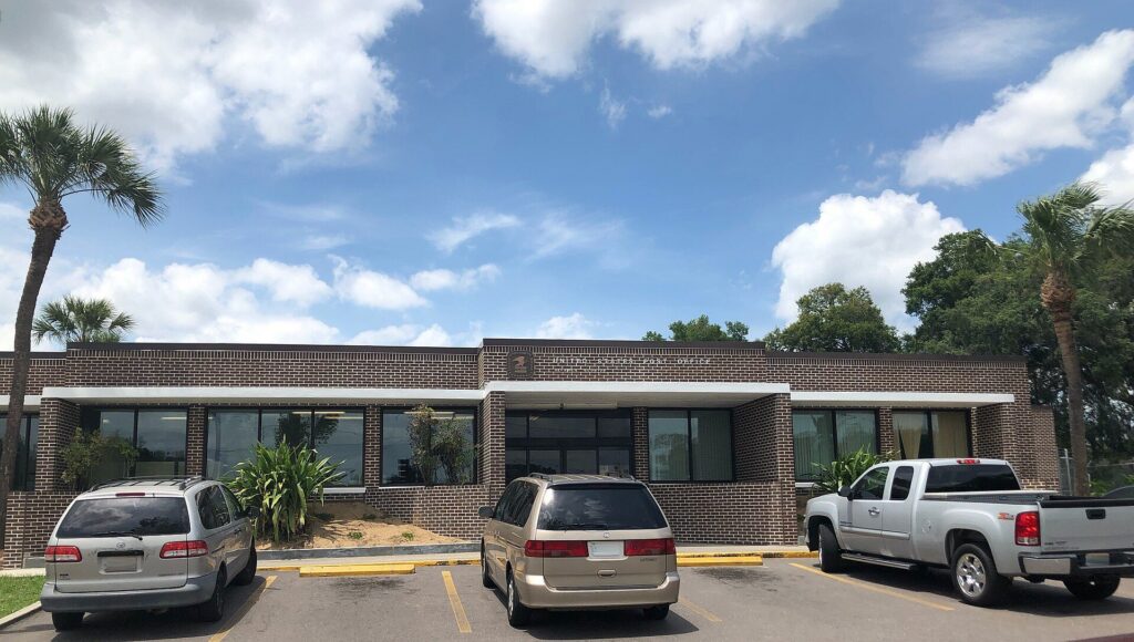 Brick Seffner post office building with palm trees in Seffner, Florida