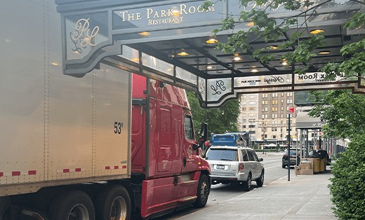 A & M Friendly Movers moving truck parked downtown